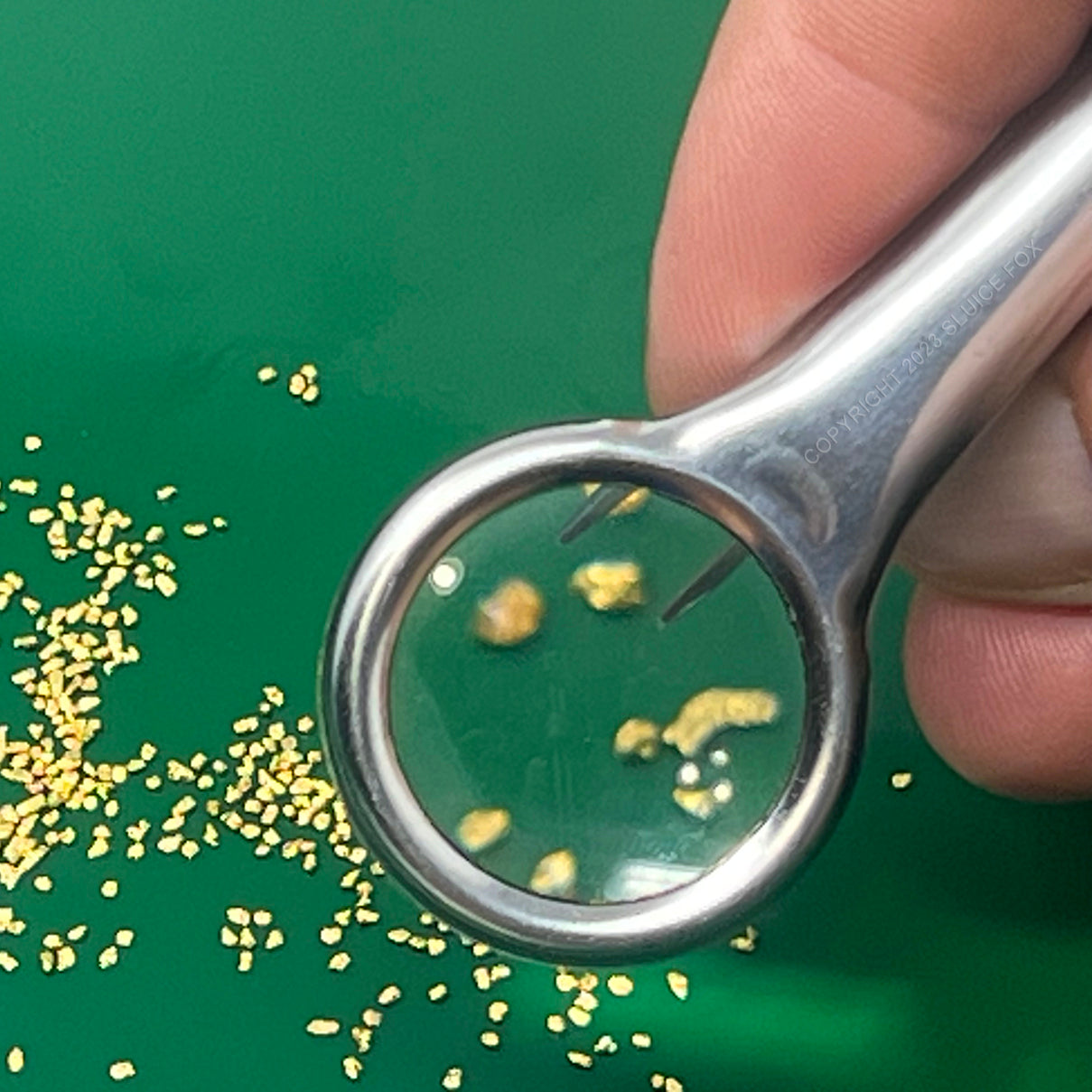 Gold panning kit for two; Two green gold pans with gold trap and dual riffles, two plastic gold paydirt shovels, two stainless steel magnifying tweezers, and three glass gold storage vials