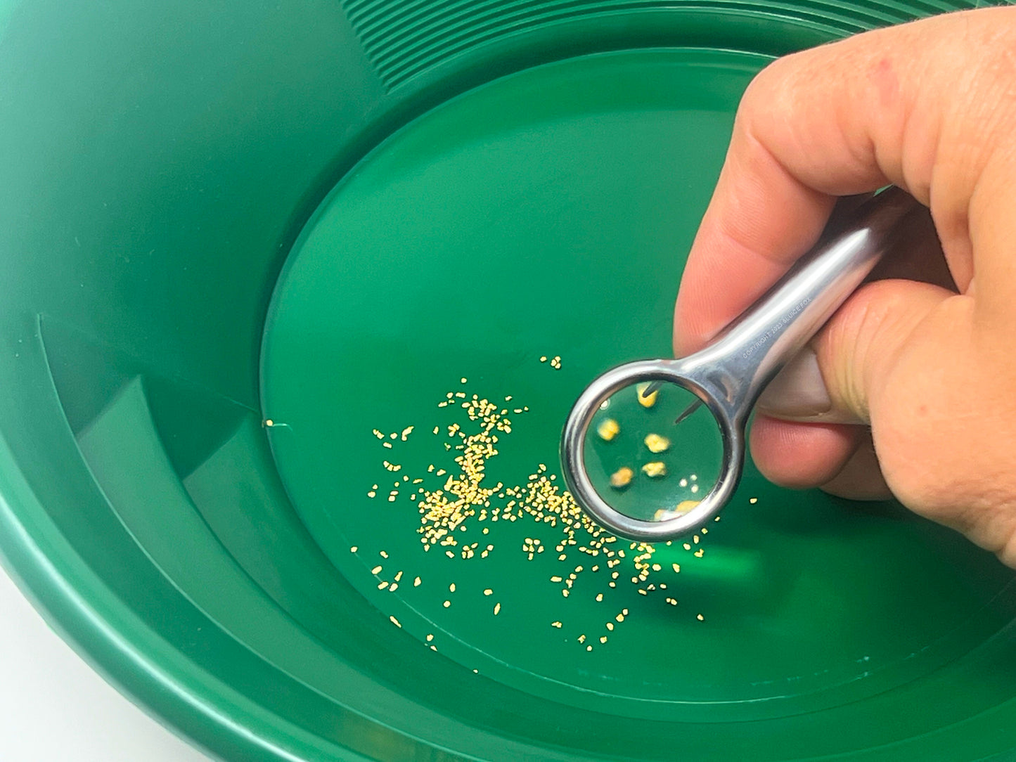 Gold panning kit for two; Two green gold pans with gold trap and dual riffles, two plastic gold paydirt shovels, two stainless steel magnifying tweezers, and three glass gold storage vials